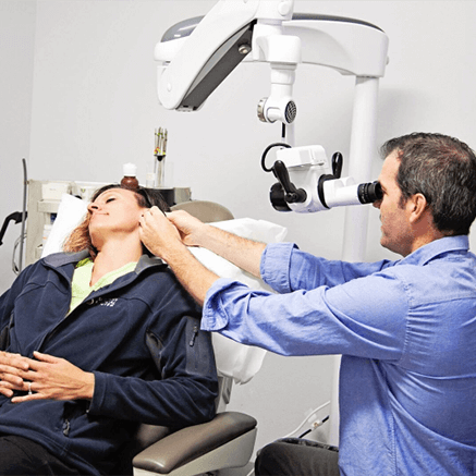 ENT showing a patient an xray of their nasal cavaties.